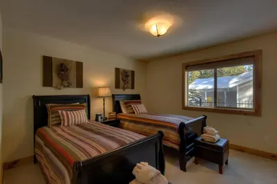 a bedroom with two beds and a window at Brand New Upscale Home, Hot Tub, Foosball in South Lake Tahoe