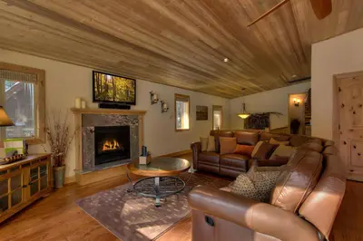 a living room with a couch and a fireplace at Brand New Upscale Home, Hot Tub, Foosball in South Lake Tahoe