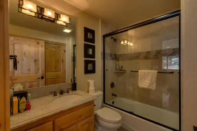 a bathroom with a shower and a sink and a toilet at Brand New Upscale Home, Hot Tub, Foosball in South Lake Tahoe