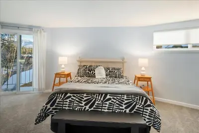 a bedroom with a bed with a black and white comforter at Private Beach, Close To Everything in South Lake Tahoe