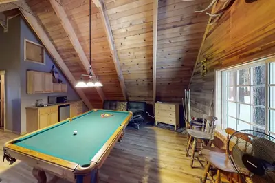 a pool table in a room with wooden walls at Walkup Pines in South Lake Tahoe