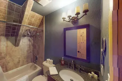 a bathroom with a sink and a toilet and a mirror at Walkup Pines in South Lake Tahoe