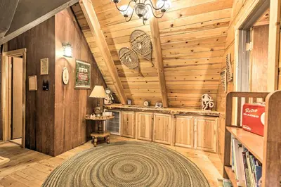 a living room with a large rug in a cabin at 8 Mi to Heavenly Mtn Resort! Hot Tub Hideaway in South Lake Tahoe