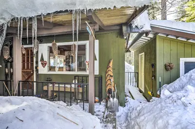 a house with skis in the snow in front of it at 8 Mi to Heavenly Mtn Resort! Hot Tub Hideaway in South Lake Tahoe