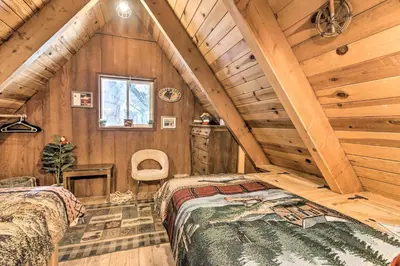 a bedroom in a log cabin with two beds at 8 Mi to Heavenly Mtn Resort! Hot Tub Hideaway in South Lake Tahoe