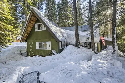 a house covered in snow in the woods at 8 Mi to Heavenly Mtn Resort! Hot Tub Hideaway in South Lake Tahoe