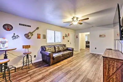 a living room with a couch and a ceiling fan at North Fork Vacation Rental 28 Mi to Yosemite in North Fork
