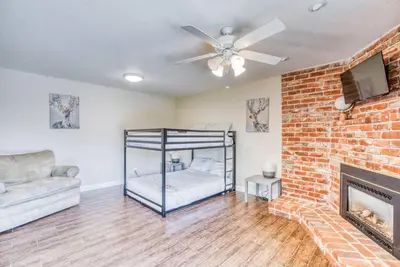 a living room with a bed and a fireplace at X-Large Spacious Deluxe House Fastest Wi-Fi in Fresno