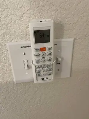 a remote control hanging on a wall at Brand New 2BR CUTE Blue LED in North Fresno in Fresno