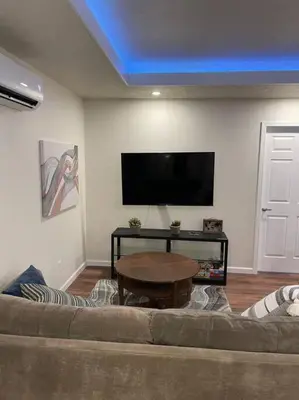 a living room with a couch and a table at Brand New 2BR CUTE Blue LED in North Fresno in Fresno