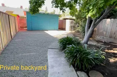 a driveway with a blue door in a yard at Brand New 2BR CUTE Blue LED in North Fresno in Fresno