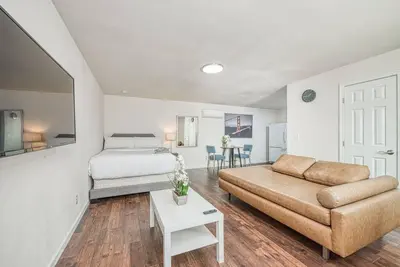 a living room with a couch and a bed at Totally New Awesome North Fresno Back Studio in Fresno