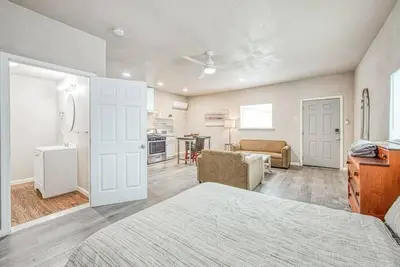 a bedroom with a bed and a living room at Stylish Studio 89 Brand New from the floor up in Fresno