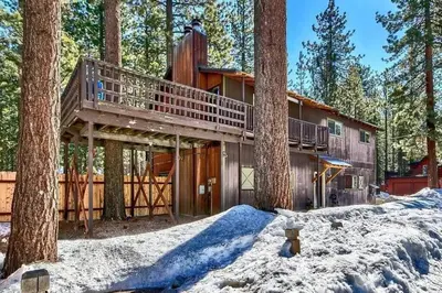 a house in the woods with a tree at Lake Views in 3bdr Family Home w/ Hottub in South Lake Tahoe
