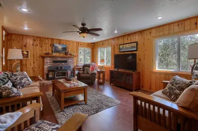 a living room with a couch and a tv at Yosemite Corner w NEW game room/Hot Tub/EV more in Oakhurst