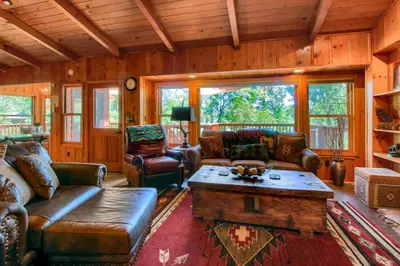 a living room with couches and a coffee table at Willow Cove Lodge- 5 bedrooms with a hot tub in Bass Lake