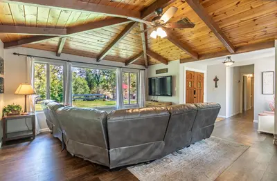 a living room with a couch and a ceiling fan at Starry Pines- Pet friendly/spa/affordable in Oakhurst
