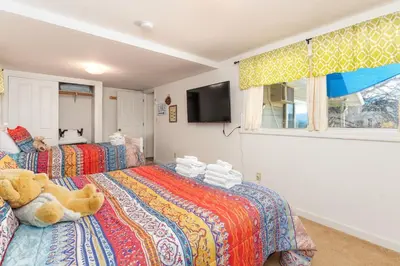 a bedroom with two beds with a teddy bear on it at Selah Cabin- Dog Friendly/BBQ/Level 2 EV Charger in Oakhurst