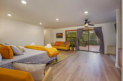 a bedroom with two beds and a balcony at Summit Cabin Stunning home Loaded with amenities in Oakhurst