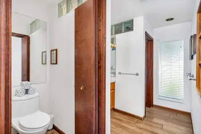 a white bathroom with a toilet and a shower at Eagles Nest at Bass Lake near Yosemite with Boat Dock in Bass Lake