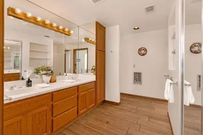 a bathroom with two sinks and a large mirror at Eagles Nest at Bass Lake near Yosemite with Boat Dock in Bass Lake
