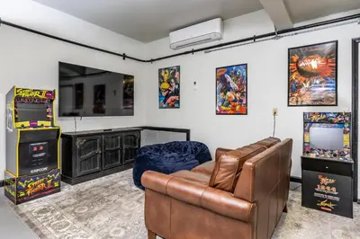 a living room with a couch and a television at River View Retreat Sleeps 16/ hot tub/basketball court in Oakhurst