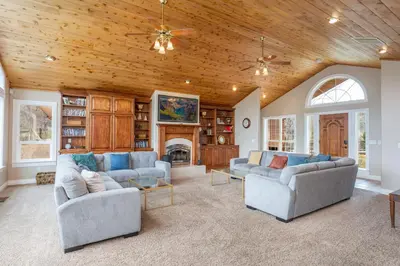a living room with two couches and a fireplace at Yosemite Adventure House with Pool-hot tub-game room in Oakhurst