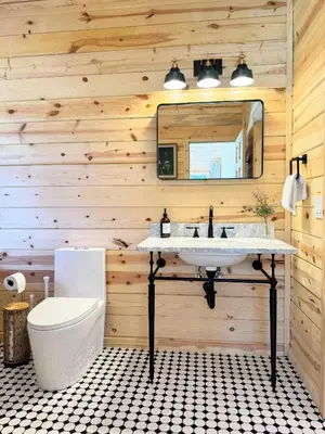 a bathroom with a sink and a mirror at Log Cabin w/ pool, spa, game room, sleeps 20 in Coarsegold
