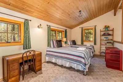a bedroom with a bed and a desk in a room at Place to Call Home - Cabin INSIDE Yosemite - Dog Friendly in South Wawona