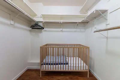 a crib in a room with a white wall at Stimboli Lodge- Sleeps 16 with tons of games and fun in Oakhurst