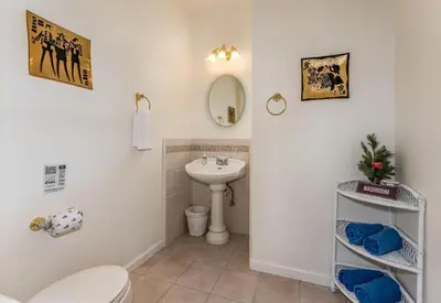 a bathroom with a toilet and a sink at Big Oak Manor w/theater/hot tub/sauna/more in Oakhurst