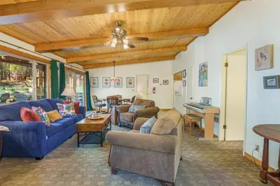 a living room with two couches and a table at Peace of Mine - Cabin inside Yosemite - Dog Friendly in South Wawona