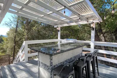a pool on a deck with a pergola at Doe Cabin Hot Tub/Playground/Game Room and more in Oakhurst