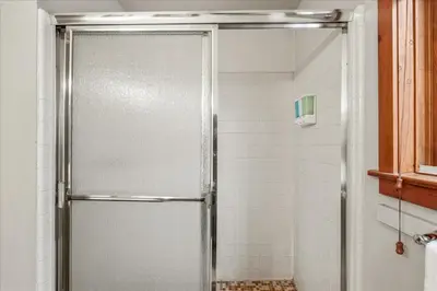 a shower with a glass door in a bathroom at Cub House- Remodeled cabin INSIDE Yosemite with new hot tub and more in North Wawona
