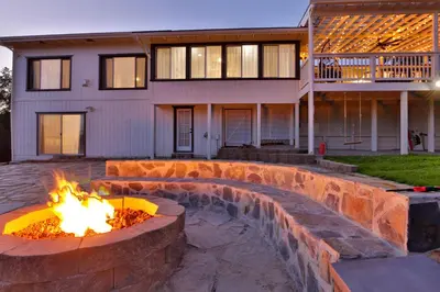 a fire pit in front of a house at Canyon View House w/ hot tub, game room, views, and more in Oakhurst