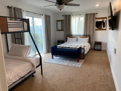 a bedroom with two bunk beds and a window at Canyon View House w/ hot tub, game room, views, and more in Oakhurst