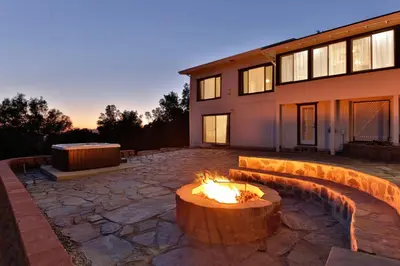 a fire pit in a yard next to a building at Canyon View House w/ hot tub, game room, views, and more in Oakhurst