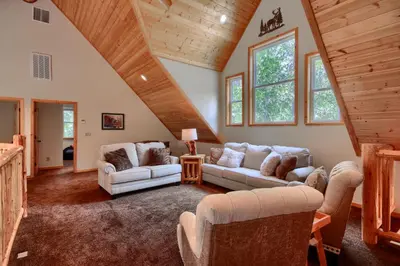 a living room with white couches and a wooden ceiling at Rivercrest Lodge with Hot Tub-Pool Table-Firepit in North Wawona