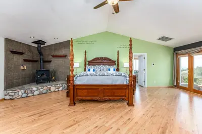 a bedroom with a bed and a fireplace at Skyline Lodge- amazing views w/spa/game room in Oakhurst