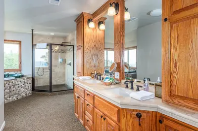 a bathroom with a double sink and a shower at Skyline Lodge- amazing views w/spa/game room in Oakhurst