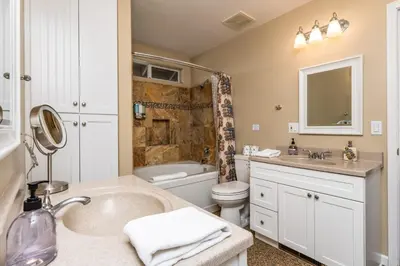 a bathroom with a sink and a toilet and a tub at Skyline Lodge- amazing views w/spa/game room in Oakhurst
