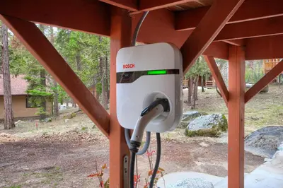 a pay phone is attached to a wooden structure at Acorn Alley- inside Yosemite w/spa/firepit/sauna/EV in North Wawona