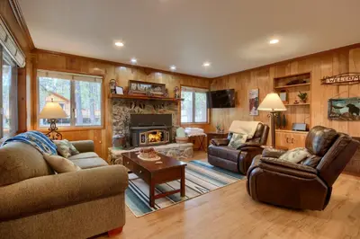 a living room filled with furniture and a fireplace at Acorn Alley- inside Yosemite w/spa/firepit/sauna/EV in North Wawona