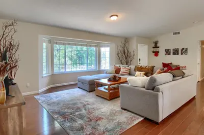 a living room with a couch and a table at Scenic Serenity 50 acres/hot tub/game room in Oakhurst