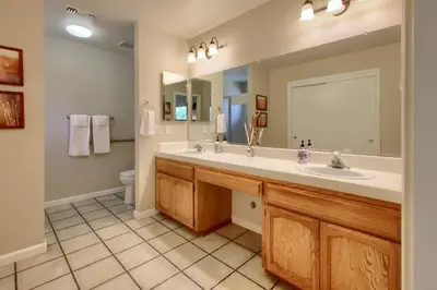 a bathroom with a double sink and a toilet at Scenic Serenity 50 acres/hot tub/game room in Oakhurst