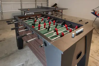 a large foosball table with avertisement for at Scenic Serenity 50 acres/hot tub/game room in Oakhurst