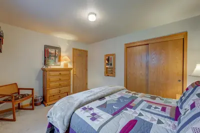 a bedroom with a bed and a wooden cabinet at Tahoe Donner Greenbelt Retreat in Truckee