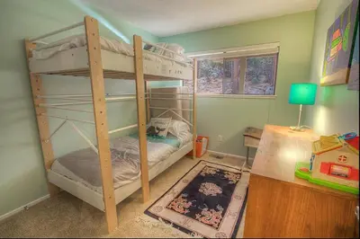 a bedroom with two bunk beds and a desk at Sugar PIne home in Incline Village
