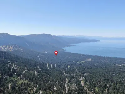 a red balloon is flying in the sky over a forest at Sugar PIne home in Incline Village