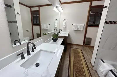 a bathroom with two sinks and a large mirror at Brookstone Pines home in Incline Village